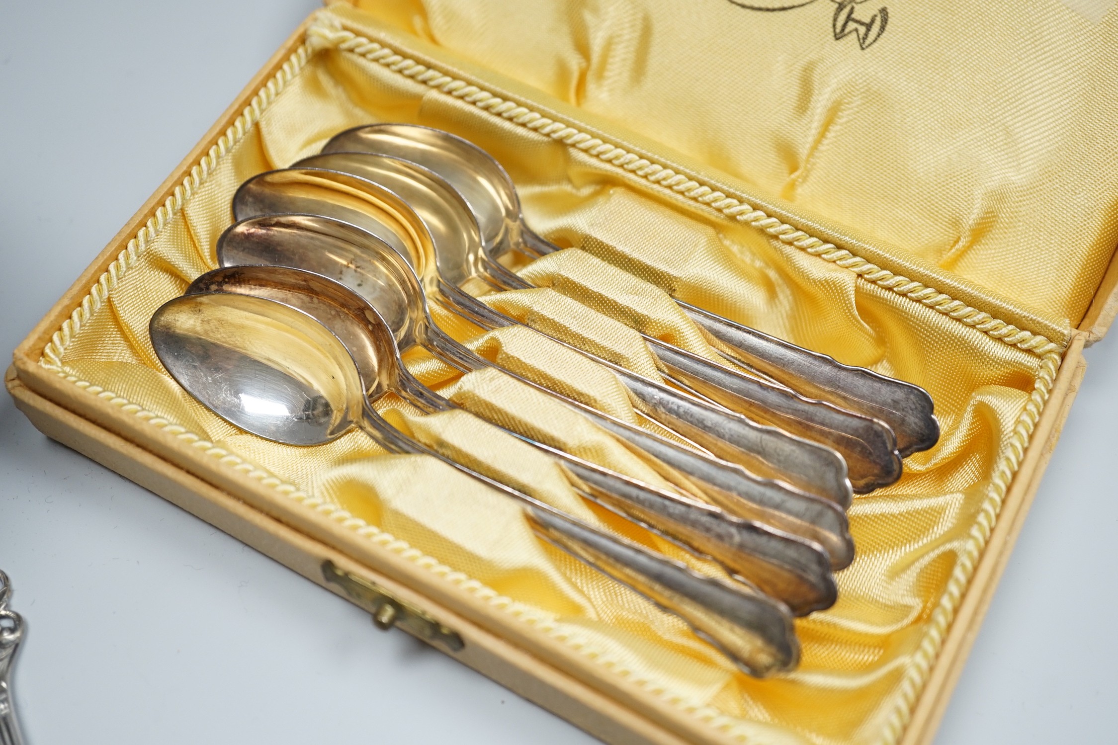 A late Victorian silver vesta case, a silver pill box, a small silver trophy cup, a cased set of six Swedish white metal coffee spoons, a similar spoon and fork and an early 20th century tow colour white metal fob watch.